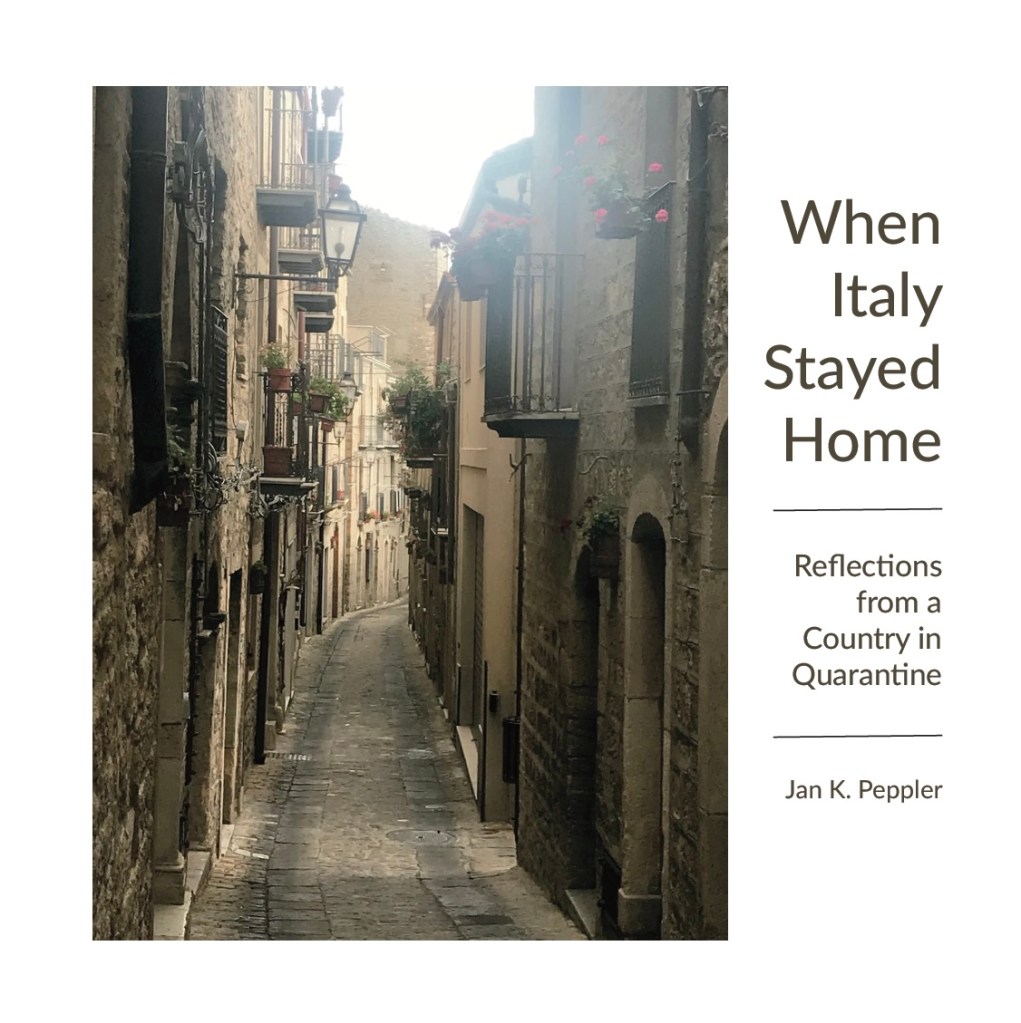 Narrow cobblestone street lined with buildings featuring balconies adorned with flowers, accompanied by the title and subtitle of a book about reflections during quarantine in Italy.